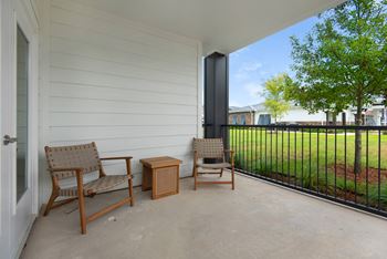 a patio with two chairs and a table on a balcony at The Enclave at Deer Moss Creek, Niceville, Florida